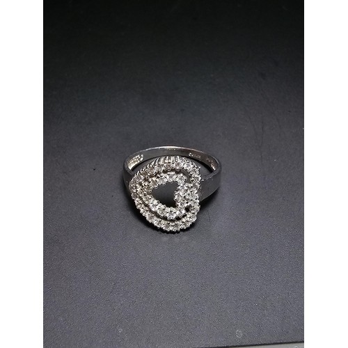 321 - Hallmarked 9ct White Gold Ring inset with a quantity of sparkly crystal CZ stones in the form of a h... 