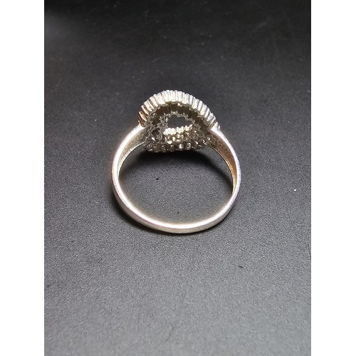 321 - Hallmarked 9ct White Gold Ring inset with a quantity of sparkly crystal CZ stones in the form of a h... 