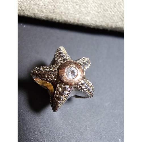 324 - Genuine Clogau 925 Silver Starfish charm featuring Clogau Gold inset with a clear Topaz stone in its... 