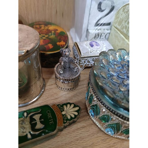 383 - A large quantity of collectable trinket boxes to include a jewelled peacock formed trinket box, deco... 