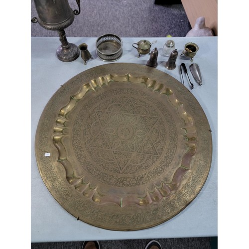 369 - Large middle eastern brass wall hanger along with a quantity plated two handled trophy cup, a bottle... 