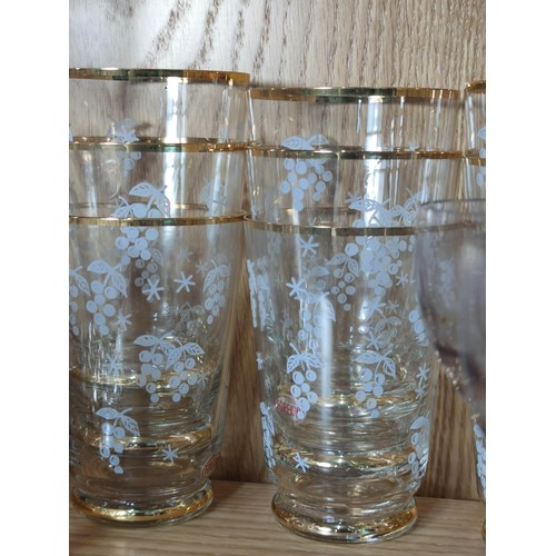 386 - A quantity of vintage glassware to include 2 gold rimmed and etched jugs with 12 matching glasses al... 