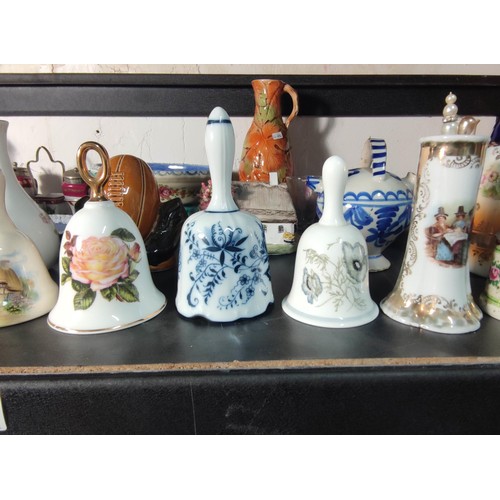 388 - A large quantity of various collectable items to include various china and glass bells, Wedgwood ite... 