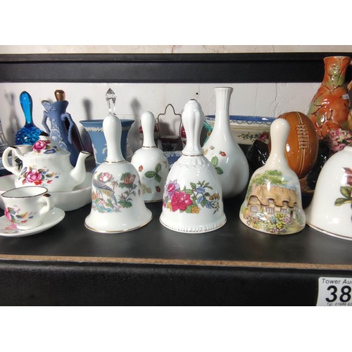 388 - A large quantity of various collectable items to include various china and glass bells, Wedgwood ite... 