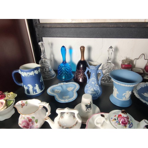 388 - A large quantity of various collectable items to include various china and glass bells, Wedgwood ite... 