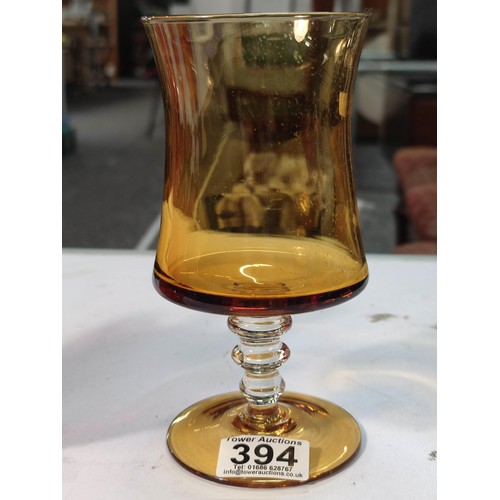 394 - A vintage amber glass chalice and a red and white handkerchief vase. Both in good condition with no ... 