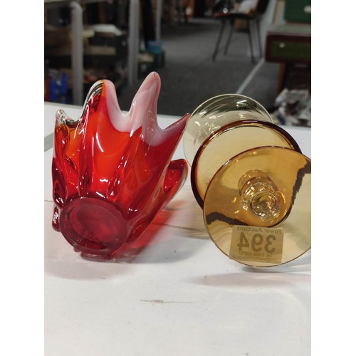 394 - A vintage amber glass chalice and a red and white handkerchief vase. Both in good condition with no ... 