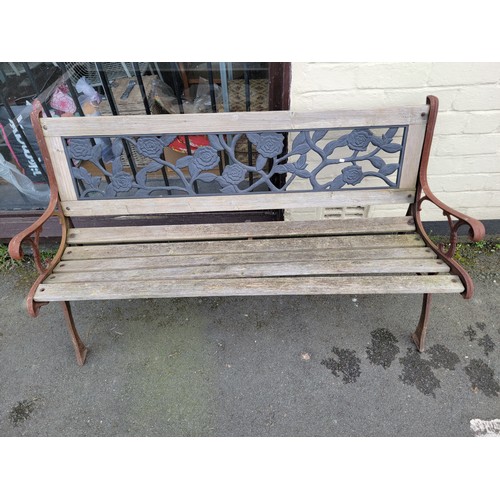 575 - A garden bench with iron sides and back