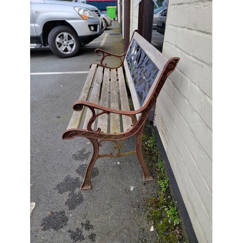 575 - A garden bench with iron sides and back