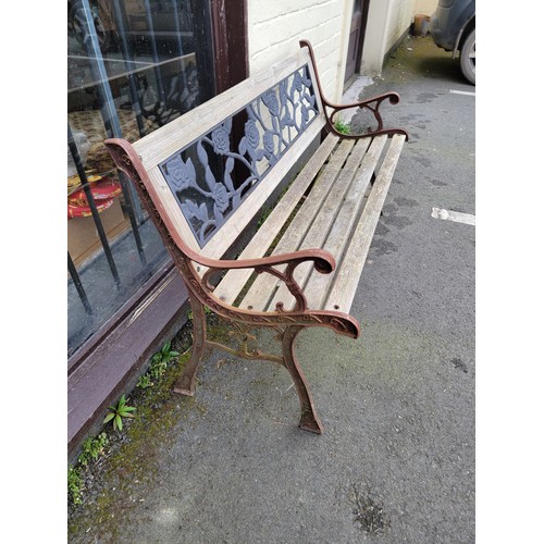 575 - A garden bench with iron sides and back