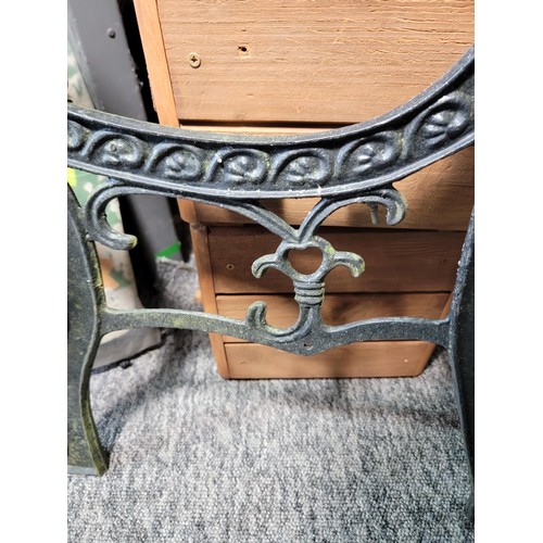 501 - Pair of black cast iron bench ends with ornate designs