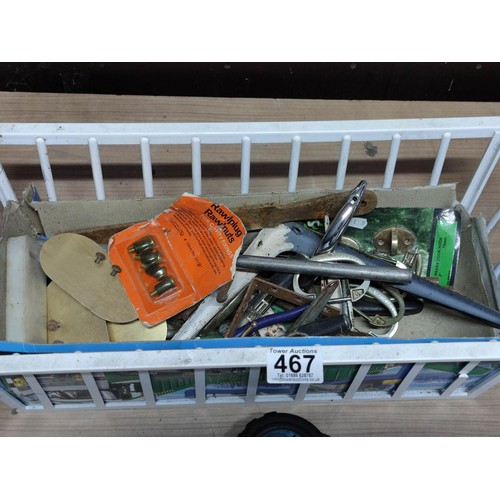 467 - Small crate containing a quantity of shed odds inc drill, brass plaques, shelf supports, tape measur... 