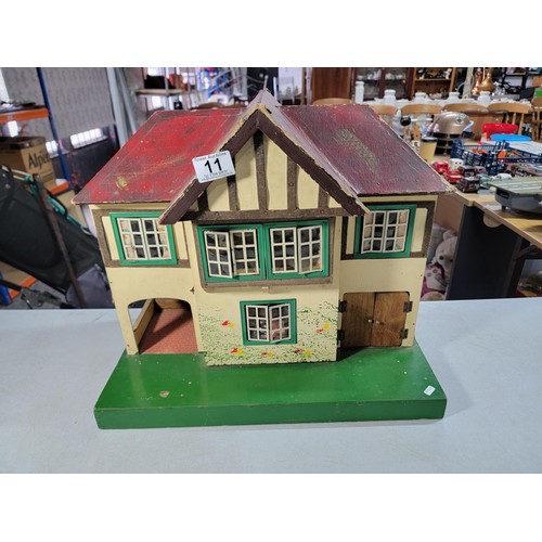 11 - Vintage 1950s Tri-ang wooden dolls house featuring metal framed windows, semi-timbered gables, and r... 