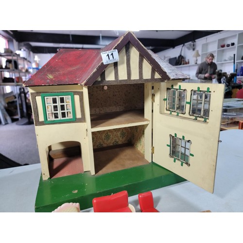 11 - Vintage 1950s Tri-ang wooden dolls house featuring metal framed windows, semi-timbered gables, and r... 