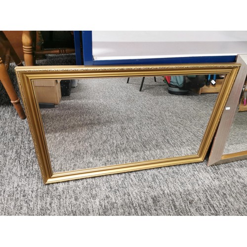 142 - 2x framed mirrors one in a silver effect frame the other in a gilt frame, largest measures 74cm high... 