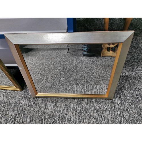 142 - 2x framed mirrors one in a silver effect frame the other in a gilt frame, largest measures 74cm high... 