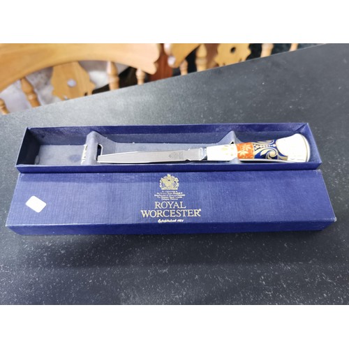 162 - A boxed Royal Worcester Golden Jubilee ceramic handle letter opener with excellent gilding to the ha... 