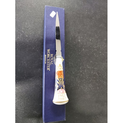 162 - A boxed Royal Worcester Golden Jubilee ceramic handle letter opener with excellent gilding to the ha... 