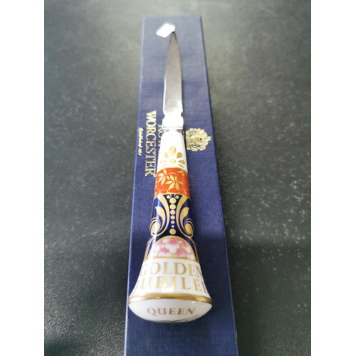 162 - A boxed Royal Worcester Golden Jubilee ceramic handle letter opener with excellent gilding to the ha... 