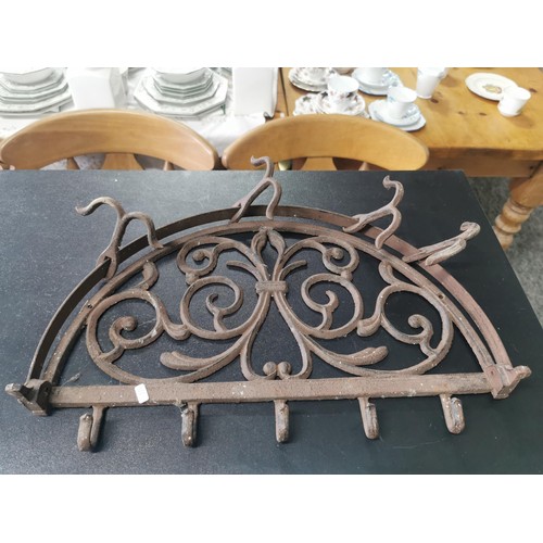 538 - Cast iron wall hanging pan rack along with a wooden lap table with lift up lid with floral cut outs,... 