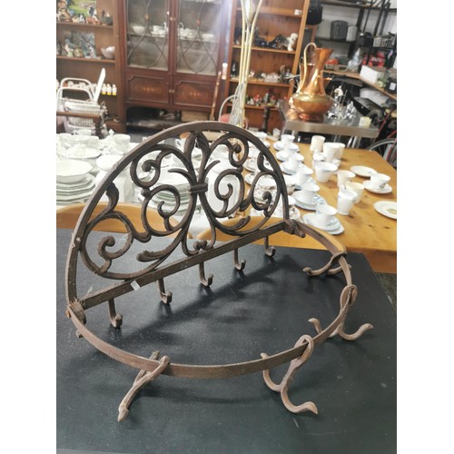 538 - Cast iron wall hanging pan rack along with a wooden lap table with lift up lid with floral cut outs,... 