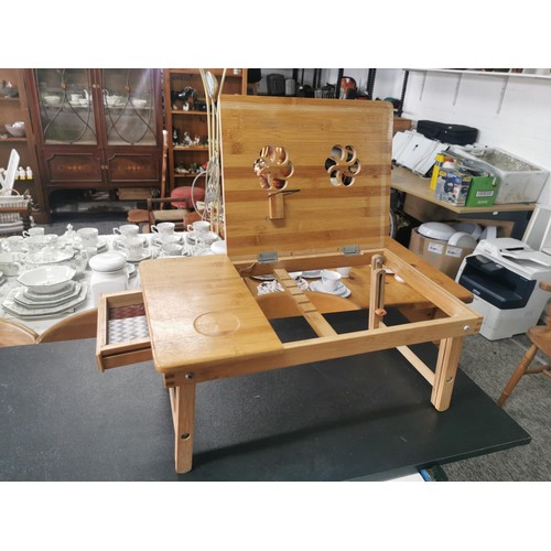 538 - Cast iron wall hanging pan rack along with a wooden lap table with lift up lid with floral cut outs,... 