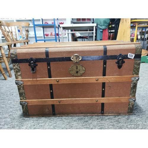 550 - Large storage trunk with timber bands in good condition its 77cm by 47cm make great coffee table