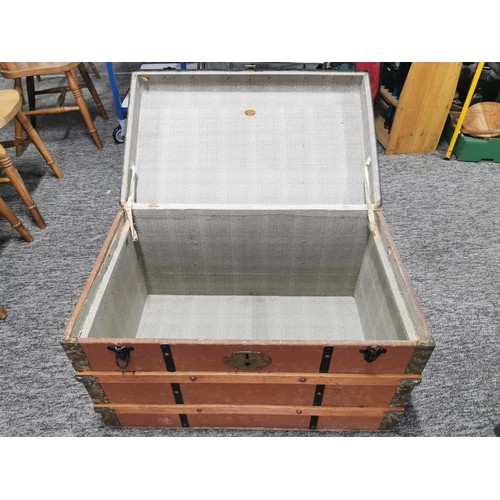 550 - Large storage trunk with timber bands in good condition its 77cm by 47cm make great coffee table