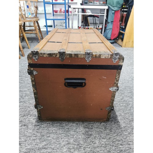 550 - Large storage trunk with timber bands in good condition its 77cm by 47cm make great coffee table