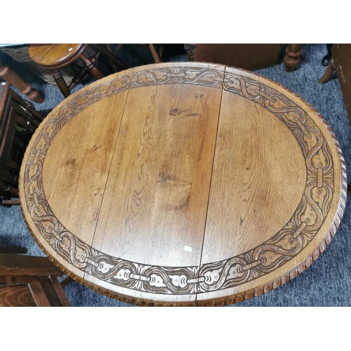 552 - A drop leaf decoratively carving to top circular  lamp or window table.
65cm diameter