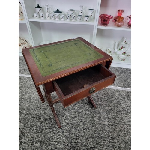 85 - A vintage green leather top regency style drop leaf occasional table. Measures with the leaves down ... 