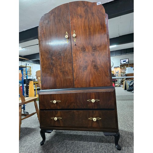 548 - An Art Deco linen chest. Walnut doors and ebonised top, with 3 inner drawers and two outer lower dra... 