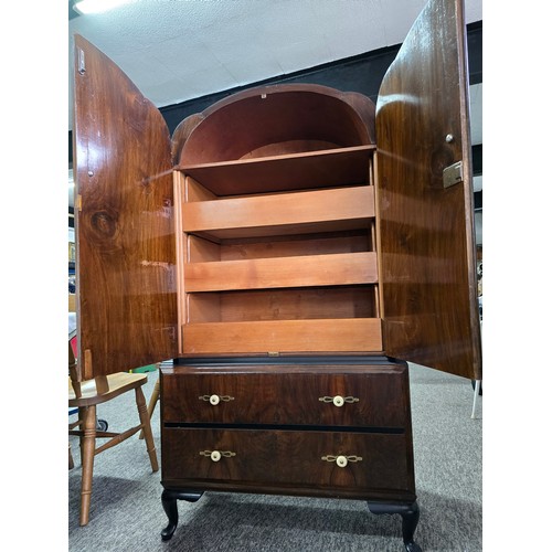 548 - An Art Deco linen chest. Walnut doors and ebonised top, with 3 inner drawers and two outer lower dra... 