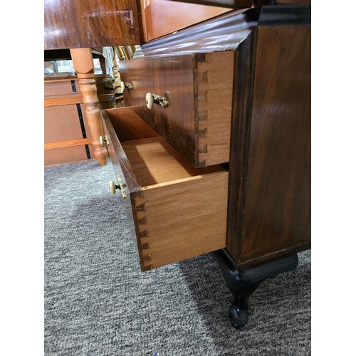 548 - An Art Deco linen chest. Walnut doors and ebonised top, with 3 inner drawers and two outer lower dra... 