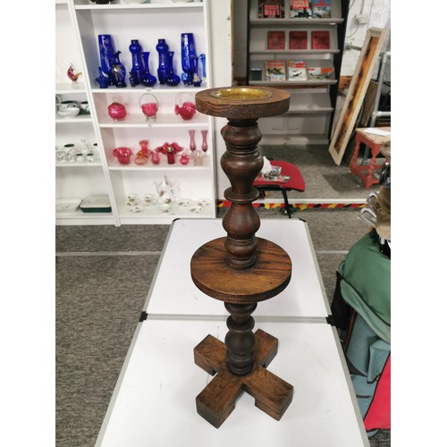 560 - Solid oak turned pillar candle stick with brass candle tray to top standing 60cm high