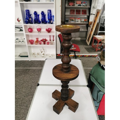 560 - Solid oak turned pillar candle stick with brass candle tray to top standing 60cm high