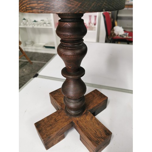 560 - Solid oak turned pillar candle stick with brass candle tray to top standing 60cm high