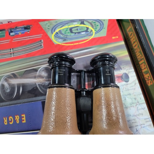 76 - 2x binoculars to include a vintage leather wrapped pair of military spotting binoculars in a good le... 