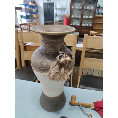 7 - Large earthen ware vase containing 2x sticks inc a twisted cane along with 3x umbrellas inc a cane h... 