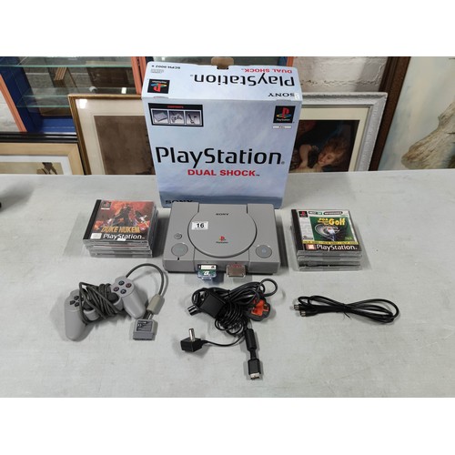 16 - A Sony Playstation dual shock edition games console along with a good selection of games. In great c... 