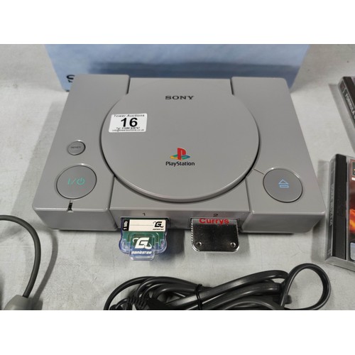 16 - A Sony Playstation dual shock edition games console along with a good selection of games. In great c... 