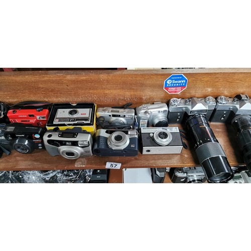 57 - A large quantity of various cameras to include SLR and digital cameras and a pair of binoculars. The... 