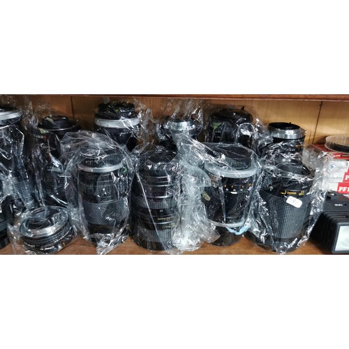 58 - A large quantity of camera lenses mostly By Canon all in excellent clean condition with most of the ... 