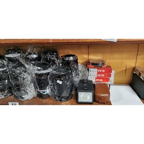 58 - A large quantity of camera lenses mostly By Canon all in excellent clean condition with most of the ... 