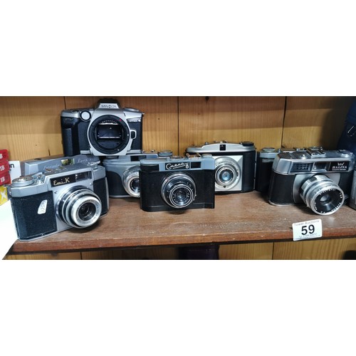 59 - A quantity of vintage cameras to include a Fujifilm digital camera, Halina, Minolta, and various Ita... 