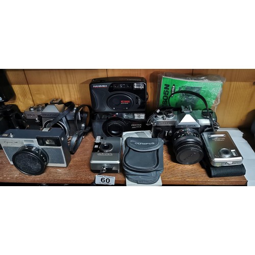 60 - A quantity of vintage cameras to include SLR film and digital cameras. Included are a Fujica ST605N ... 