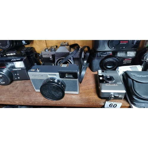 60 - A quantity of vintage cameras to include SLR film and digital cameras. Included are a Fujica ST605N ... 