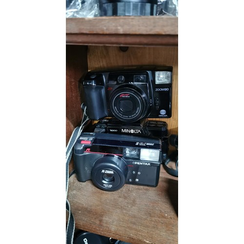 60 - A quantity of vintage cameras to include SLR film and digital cameras. Included are a Fujica ST605N ... 