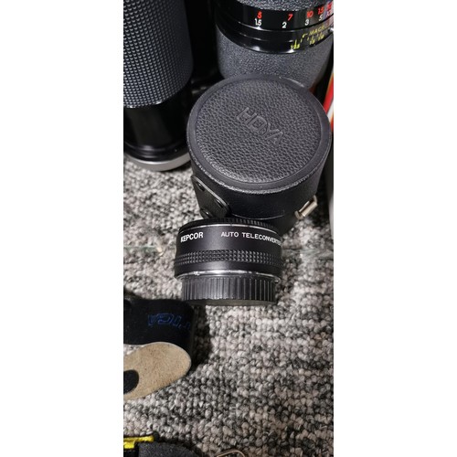 65 - A quantity of camera lenses to include a Tamrom, Zoom macro lens, a Kiron macro zoom lens, a tele co... 