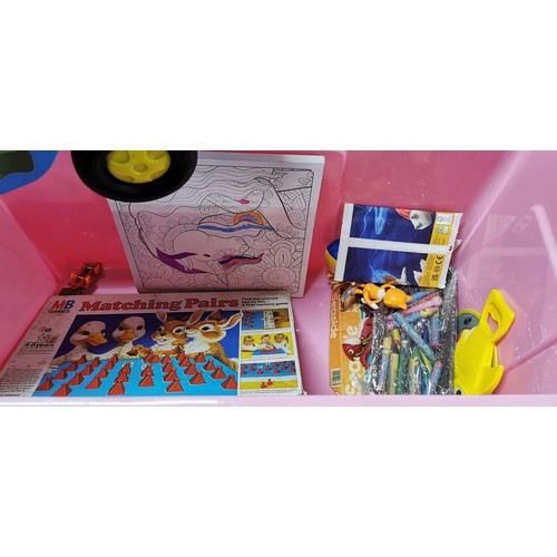 67 - A large quantity of Children's toys in a large pink storage box to include Crazy Can Alley, a ride o... 